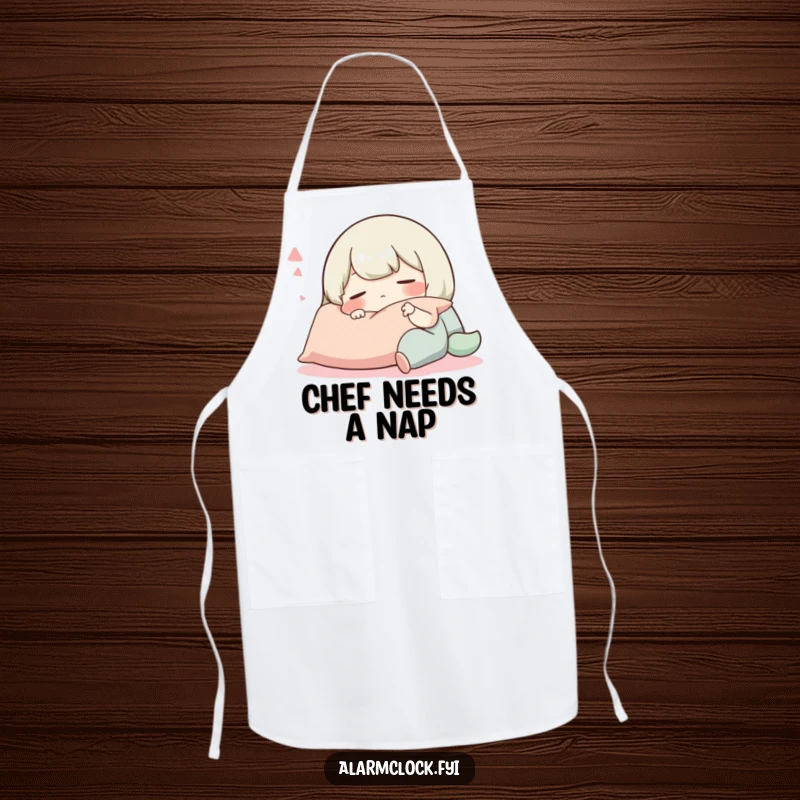 Funny apron featuring a happily sleeping character resting on a pillow, perfect for a humorous and relaxed kitchen experience.