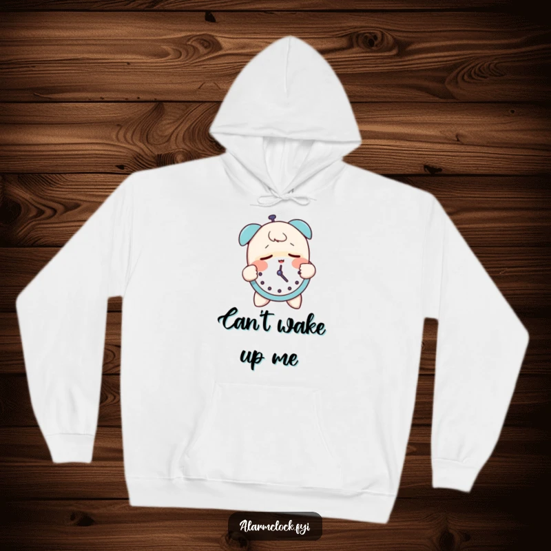 Funny hoodie showing a sleepy character groggily slapping an alarm clock, perfect for those who need extra motivation to wake up.